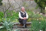 Peter Cundall sitting surrounded by plants