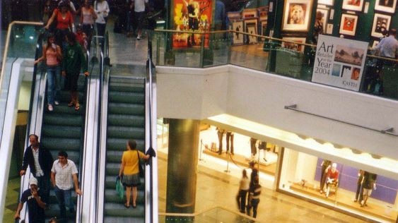 Shoppers on an elevator in a shopping centre