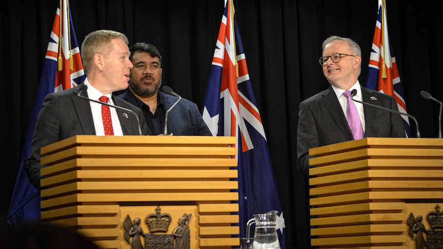 Chris Hipkins and Anthony Albanese standing at podiums at a press conference. 