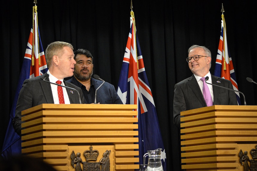 Chris Hipkins and Anthony Albanese standing at podiums at a press conference. 