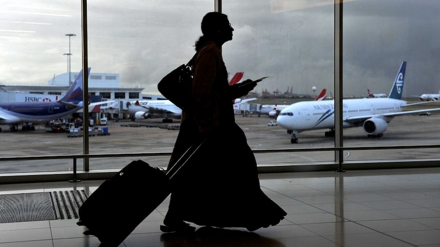 An unidentifiable woman walks through Sydney airport