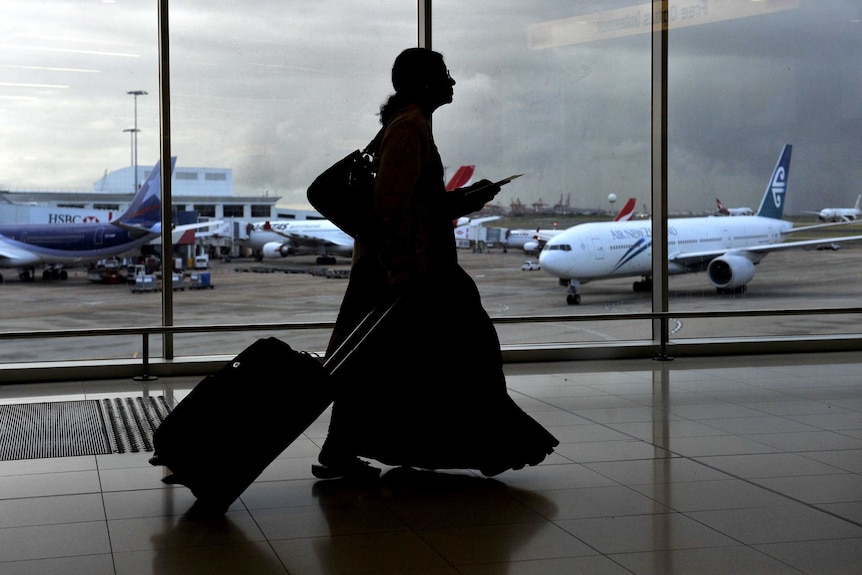 An unidentifiable woman walks through Sydney airport