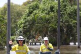 Ergon Energy technicians wade through Quay Street floodwater in Rockhampton