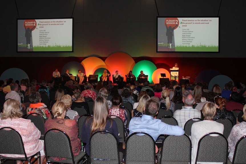 A shot of a conference floor with around 200 people in attendance