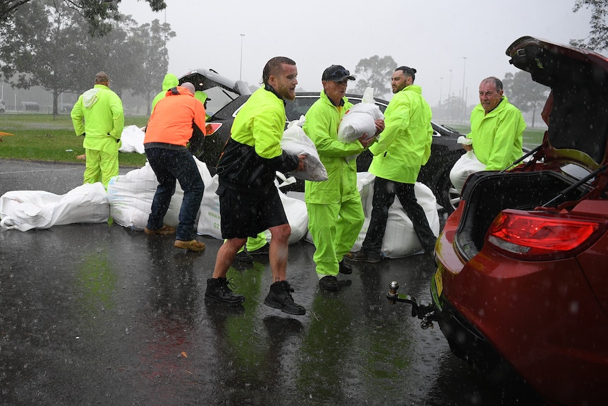 People carrying sandbags