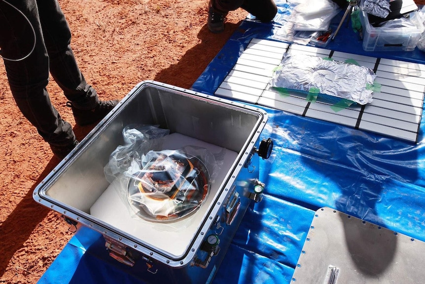 A box containing a capsule recovered from space.