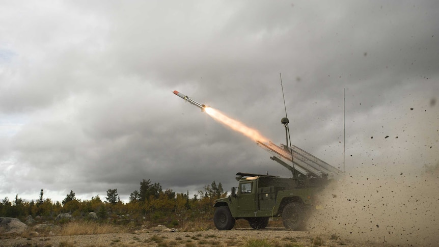 A NASAMS AMRAAM missile is launched from a High Mobility Launcher.