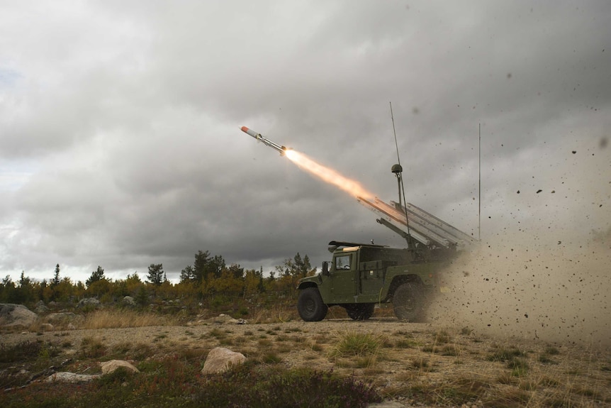 A NASAMS AMRAAM missile is launched from a High Mobility Launcher.
