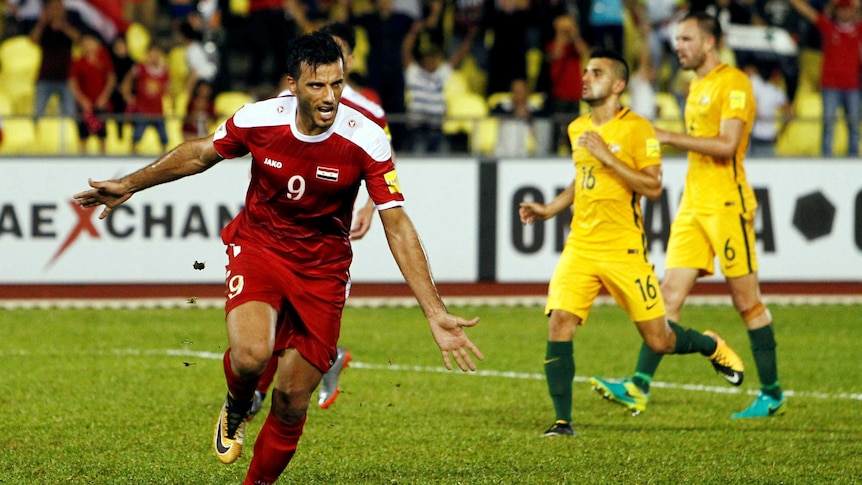 Syria's Omar Al Soma celebrates penalty against Socceroos