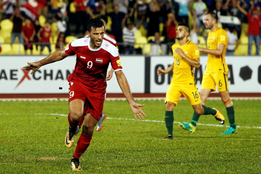 Syria's Omar Al Soma celebrates penalty against Socceroos