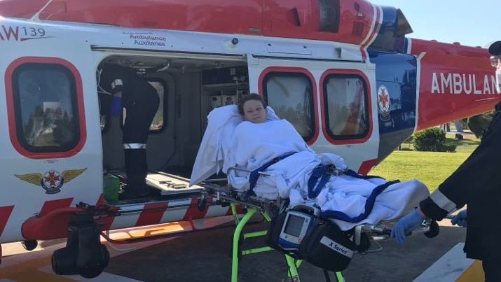 Kalem in a stretcher about to enter a helicopter ambulance.
