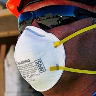 A man wearing a white face mask