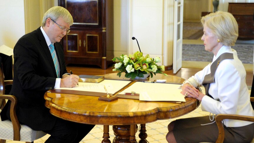 Kevin Rudd signs his commission as Prime Minister at Government House after leadership win.