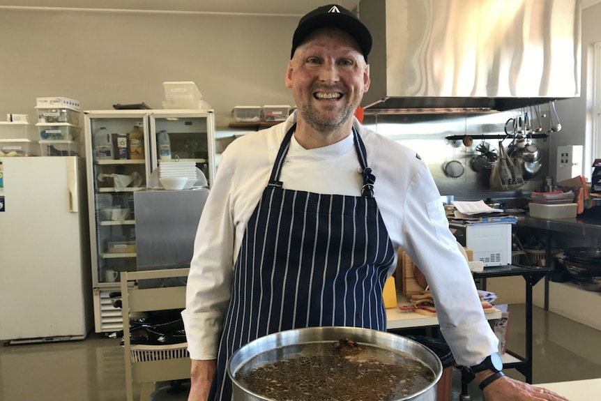 Celebrity Matt Golinski poses next to a pot full of bone broth.