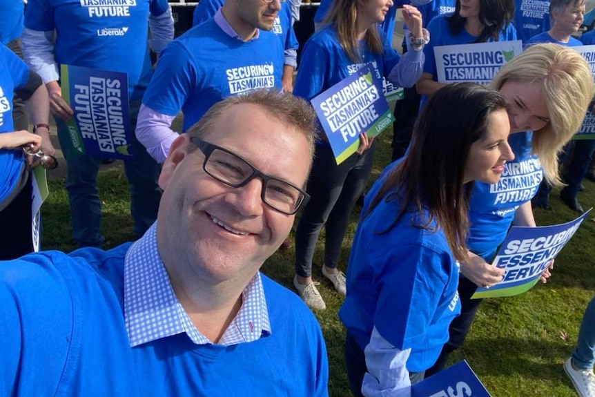 Adam Brooks selfie photo in a group of people.