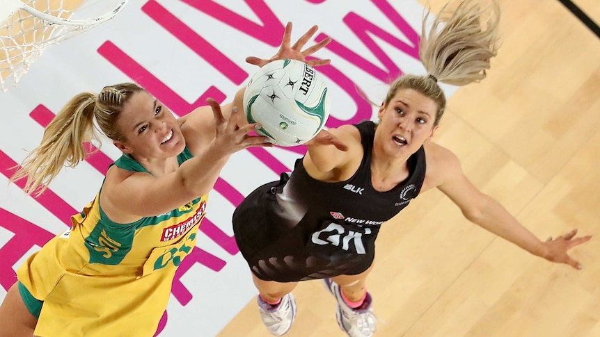 New Zealand's Jane Watson (R) and Australia's Caitlin Bassett compete in Netball Quad Series final.