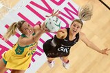 New Zealand's Jane Watson (R) and Australia's Caitlin Bassett compete in Netball Quad Series final.