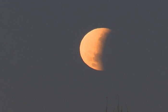 red partial lunar eclipse in the sky