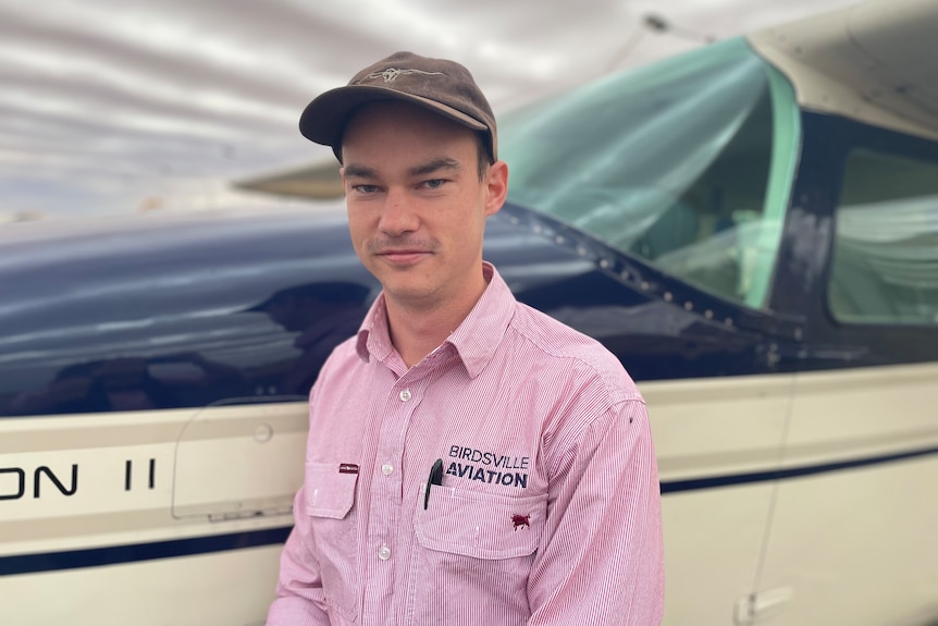 Pilot Jonathon Rae stands next to a plane