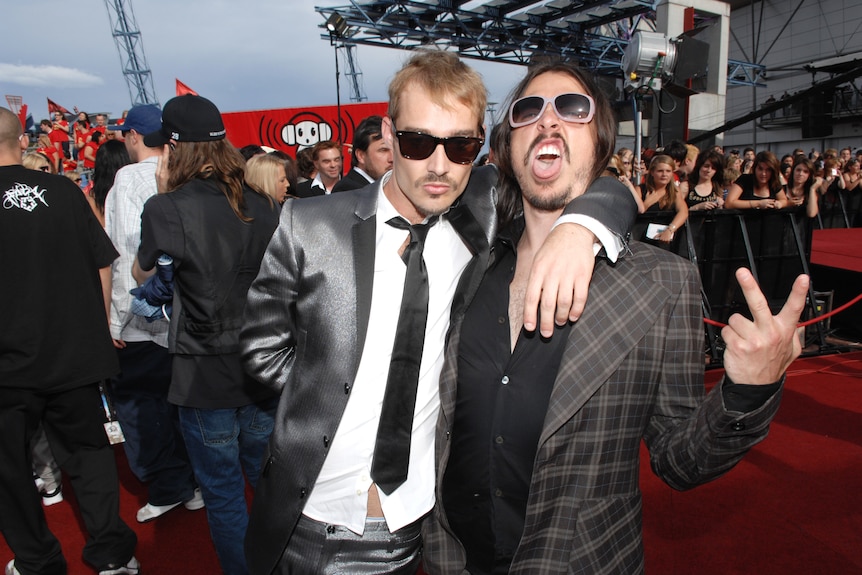 Two men pose on the red carpet