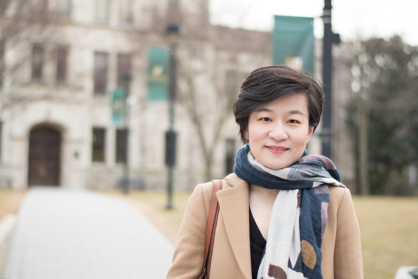 A woman standing in an university campus