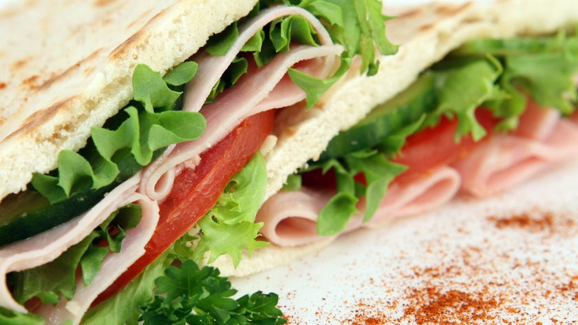 Close up shot of a ham and salad sandwich