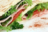 Close up shot of a ham and salad sandwich
