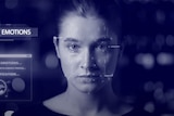 In a still from a video, a woman's face is scanned while the words "analysis of emotions" are shown.