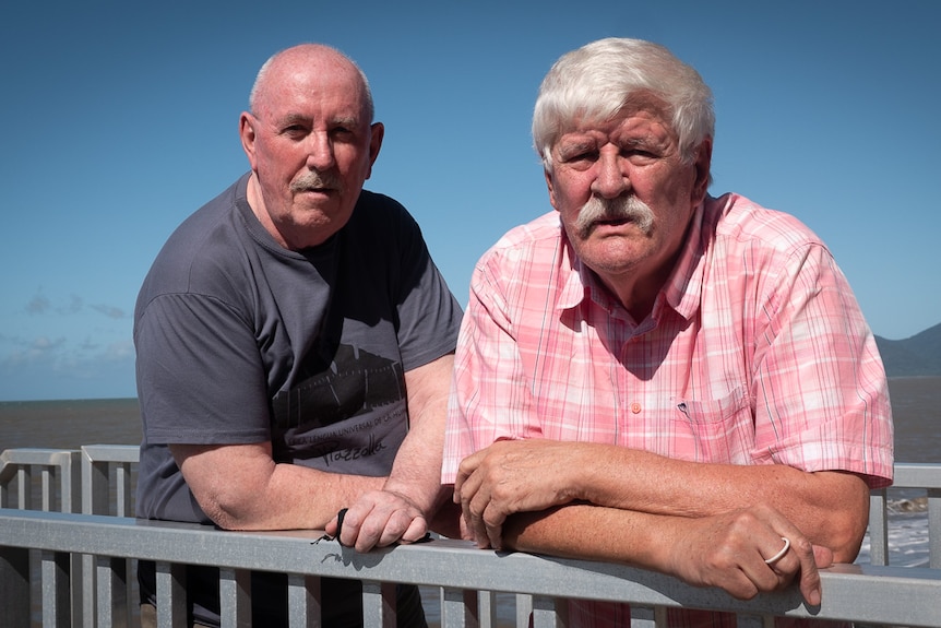 Two men beside beach