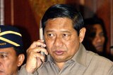 Susilo Bambang Yudhoyono speaks on his mobile phone