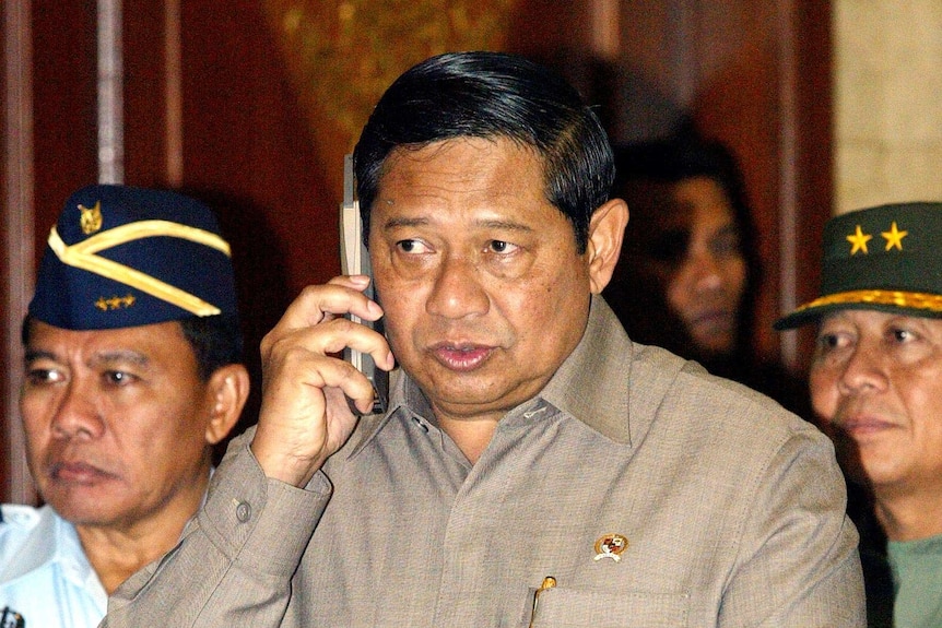 Susilo Bambang Yudhoyono speaks on his mobile phone