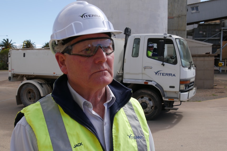 A man in high viz clothing and a hard hat