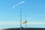 A missile trace above a Ukraine flag.