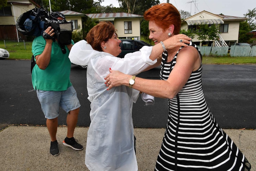 One Nation leader Senator Pauline Hanson (right) and ALP member for Bundamba, Jo-Ann Miller (left) are seen greeting each other