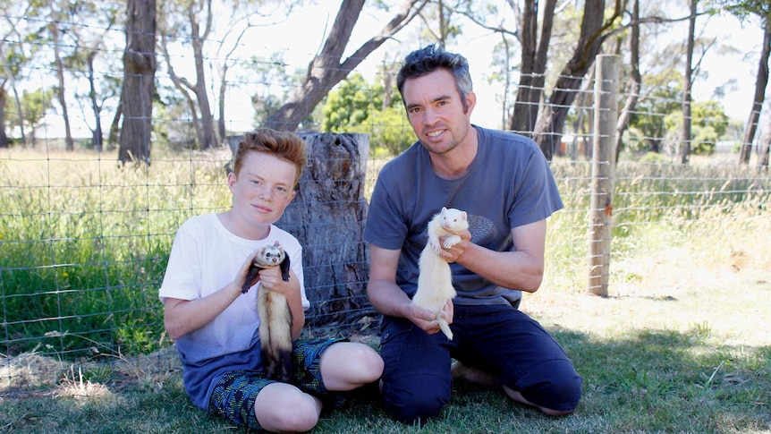 Daniel and William Bowden holding their ferrets