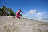 Fisherman casts net in Tuvalu