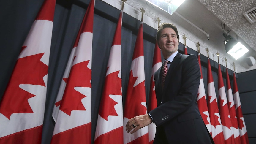 Canadian Prime Minister Justin Trudeau with flags