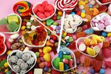 Top-down view of table covered in colouful assortment of sugary treats and chocolates