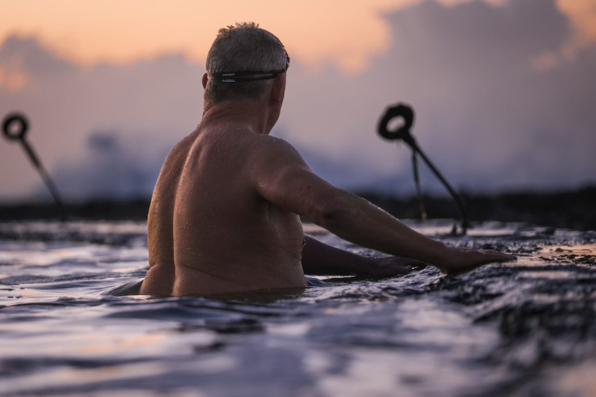 Paul Smith's turns his back at sunrise at the ocean baths