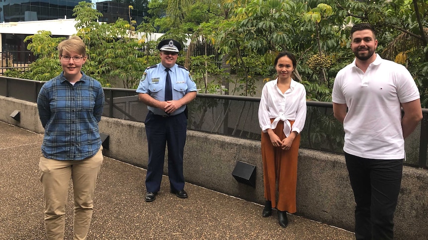 three UOW students standing with police commissioner