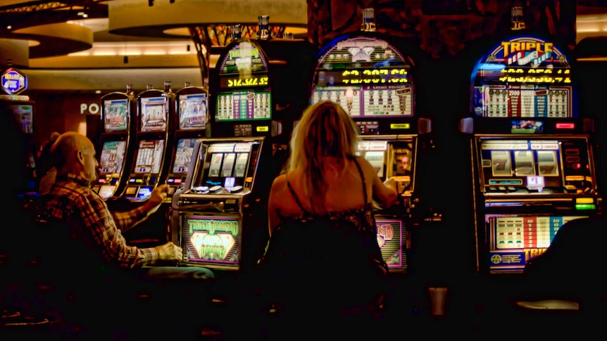 People playing pokie machines