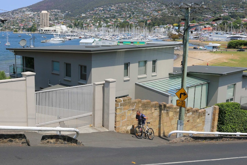 Cyclist doing it tough on Napoleon Street in Battery Point, Hobart's steepest incline.