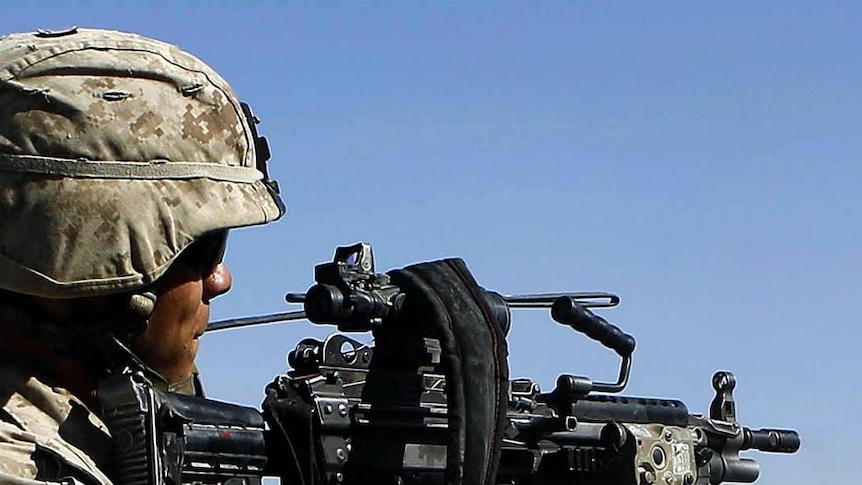 A US Marine fires his weapon during a battle against Taliban insurgents