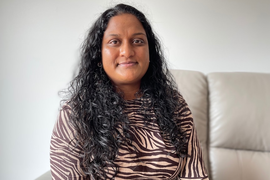 Thudhena sitting in the lounge of her new home in Berwick.