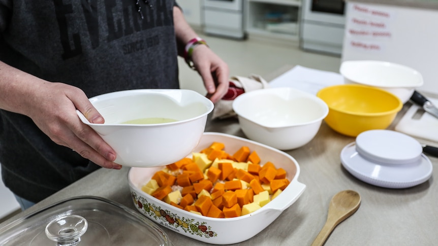 Preparing baked pumpkin risotto.