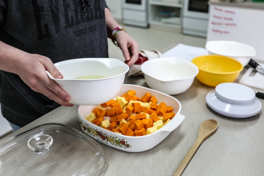 Preparing baked pumpkin risotto.