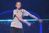 a boy dances in a backpack
