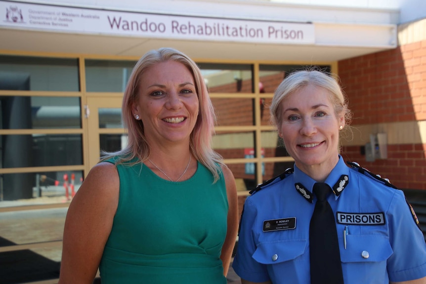 Wandoo manager Peta Hughes and Superintendent Susan Rowley stand in front of a prison sign.