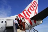 NT Airports chief executive Ian Kew with NT Tourism Minister Lauren Moss and Virgin staff.