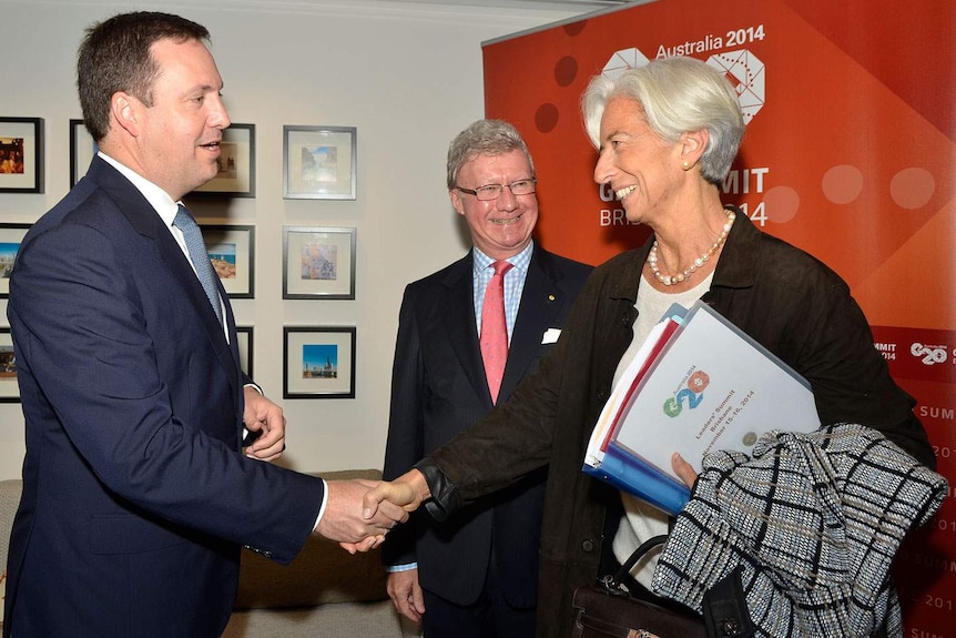 IMF managing director Christine Lagarde is greeted by federal frontbencher Steven Ciobo (left) and Queensland Governor Paul de Jersey at Brisbane Airport.